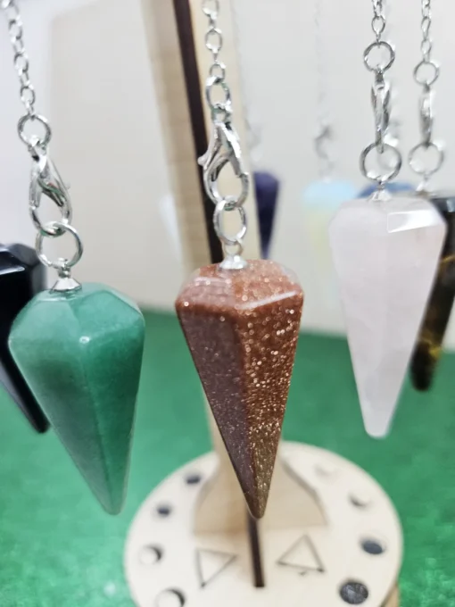 natural jasper-gemstone-pendulums-on-wooden-rack.jpg