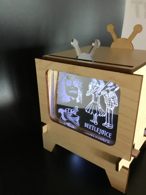 Laser-engraved themed acrylic insert glowing inside vintage-style TV frame