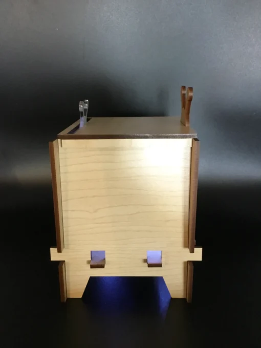 Side view of wooden retro TV box showing glowing light from vent slats.