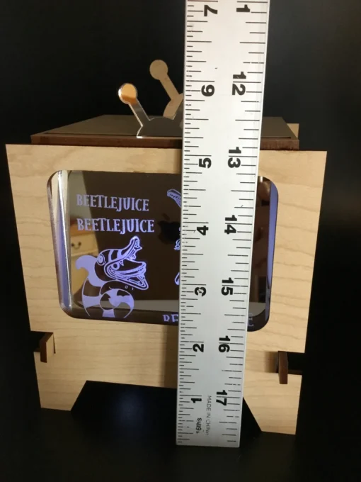 Measuring height of custom lightbox display with ruler.