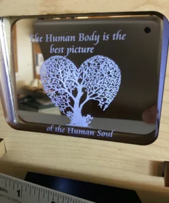 Close-up of interchangeable acrylic insert with ‘The Human Body is the best picture of the Human Soul’ quote.