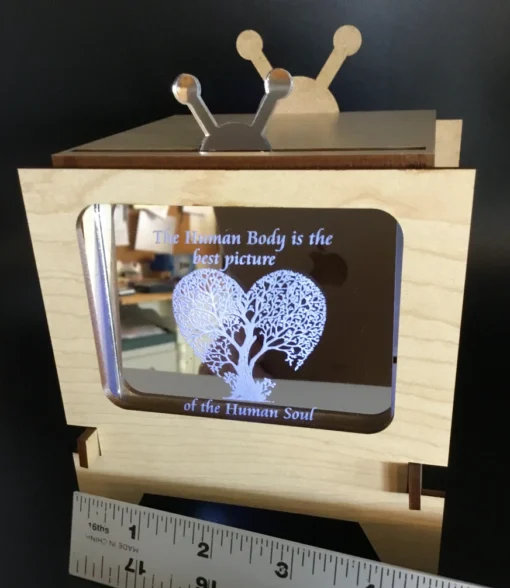 Close-up of interchangeable acrylic insert with ‘The Human Body is the best picture of the Human Soul’ quote