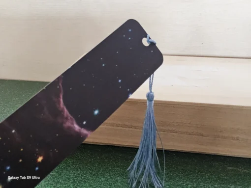 Cosmic galaxy design bookmark with blue tassel