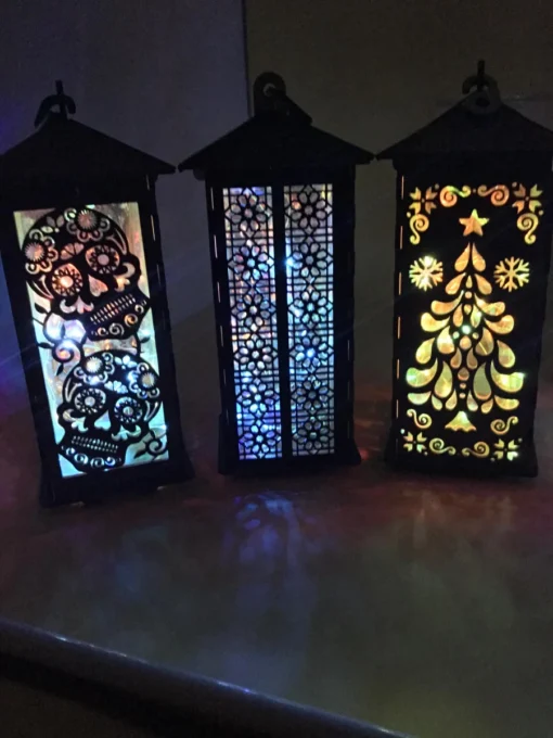 Wooden lanterns with sugar skull, floral lattice, and Christmas tree cutouts