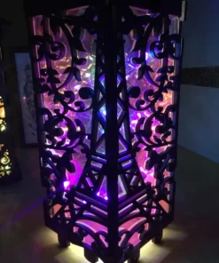 Close-up of Eiffel Tower-themed LED lantern with colorful glowing interior.