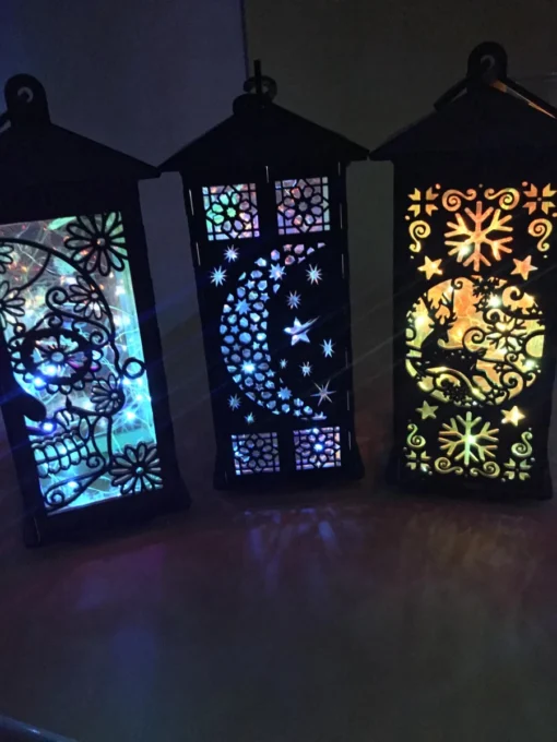 A close-up of handcrafted wooden lanterns showcasing intricate cutouts before illumination.