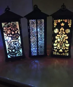 A close-up of handcrafted wooden lanterns showcasing intricate cutouts before illumination. 01