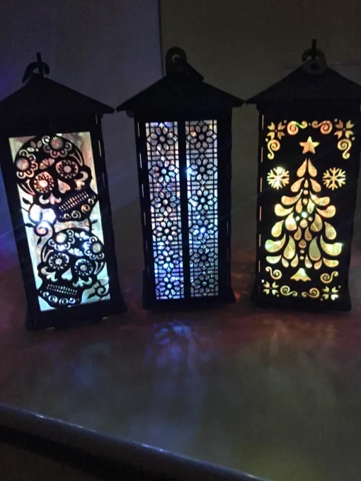A close-up of handcrafted wooden lanterns showcasing intricate cutouts before illumination. 01