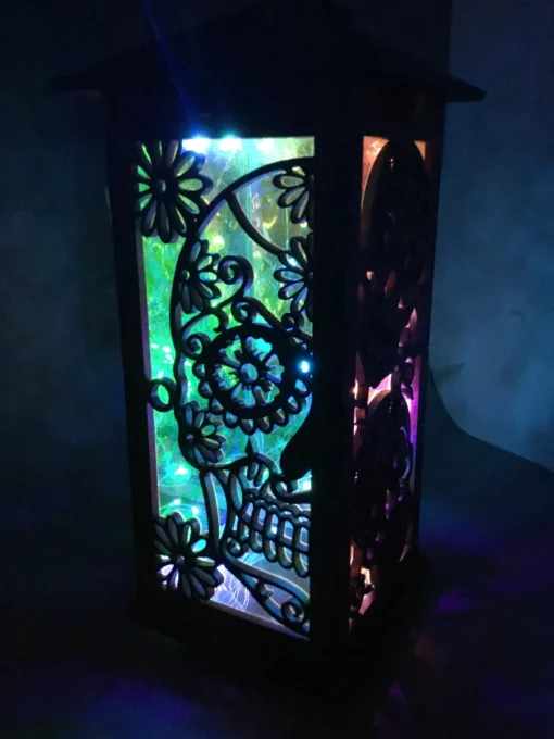 Tall, intricately carved sugar skull lantern illuminated with colorful LEDs, approximately 12 inches in height, perfect for festive or mystical décor.